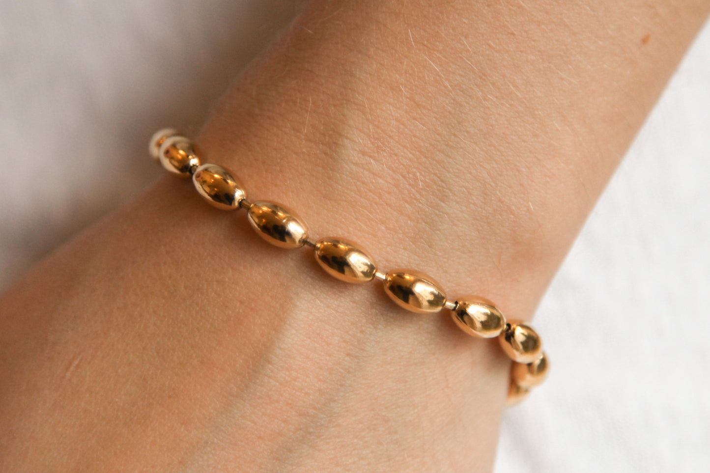 Bracelet perles ovales en acier inoxydable doré