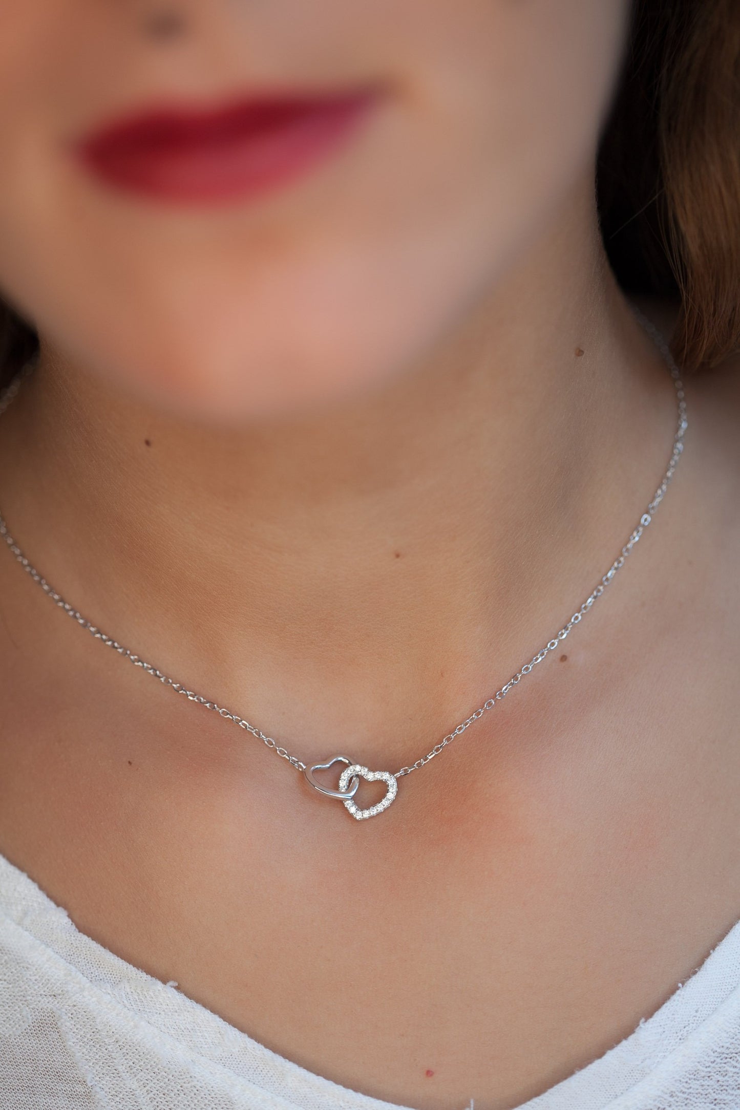 Collier 2 coeurs entrelacés en argent serti de zircons