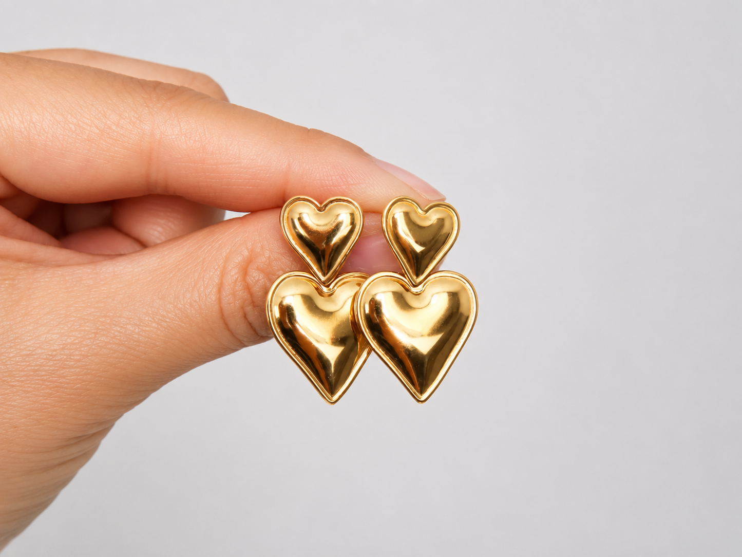 Boucles d’oreilles pendantes double coeurs en acier doré