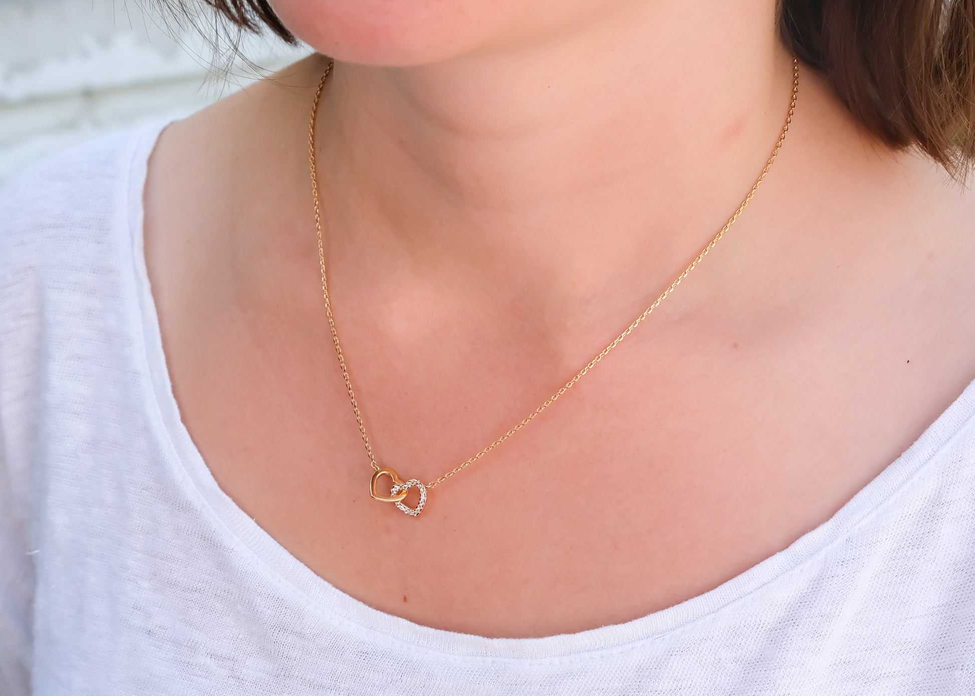 Collier coeurs entrelacés serti de zircons plaqué or